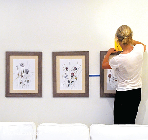 How to hang 3 pictures above a couch